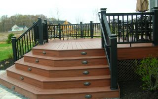 custom built brown wooden deck with black railing