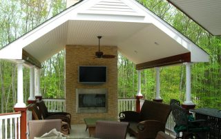covered patio with television and fireplace